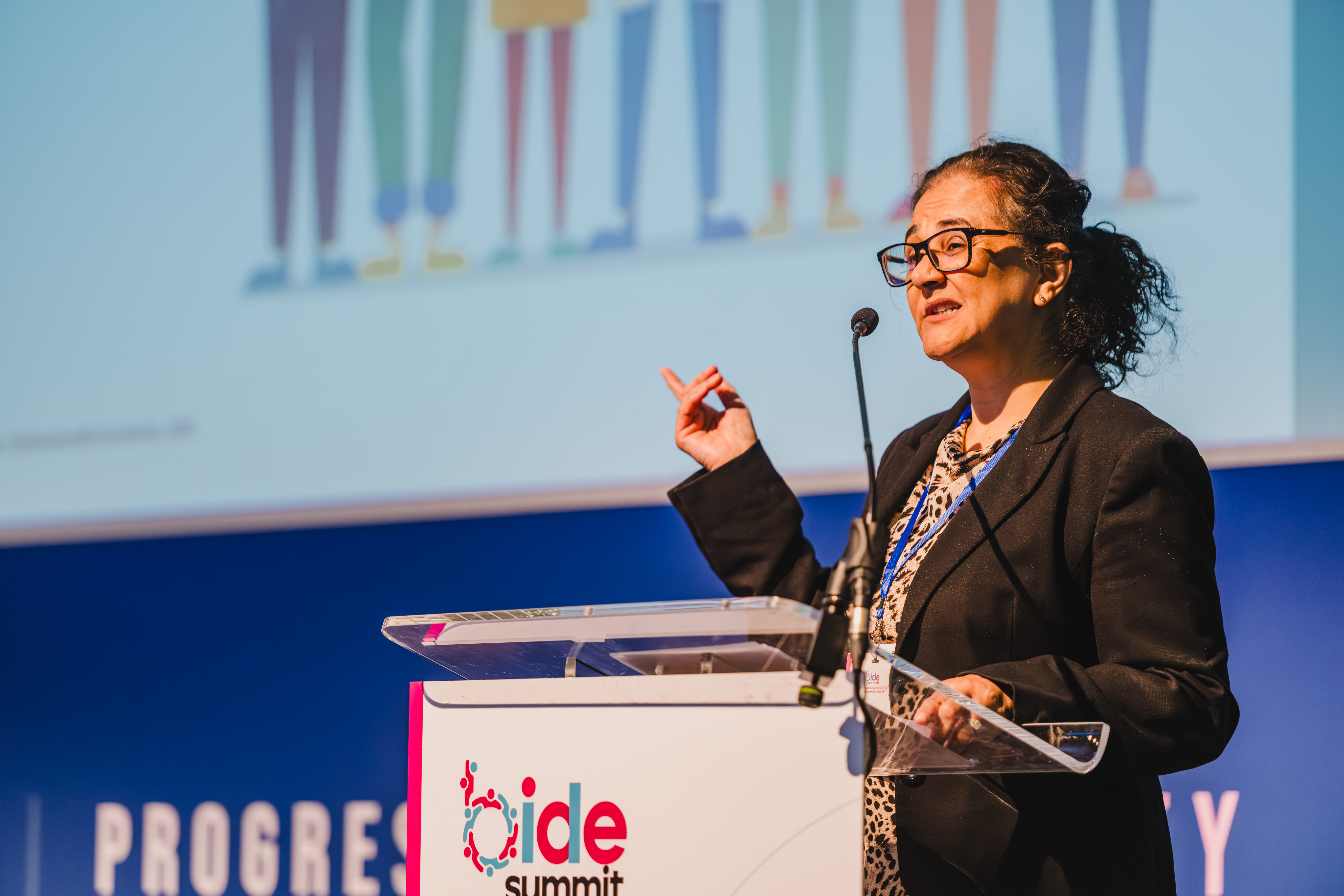 B.I.D.E summit presenter discussing a projected slide