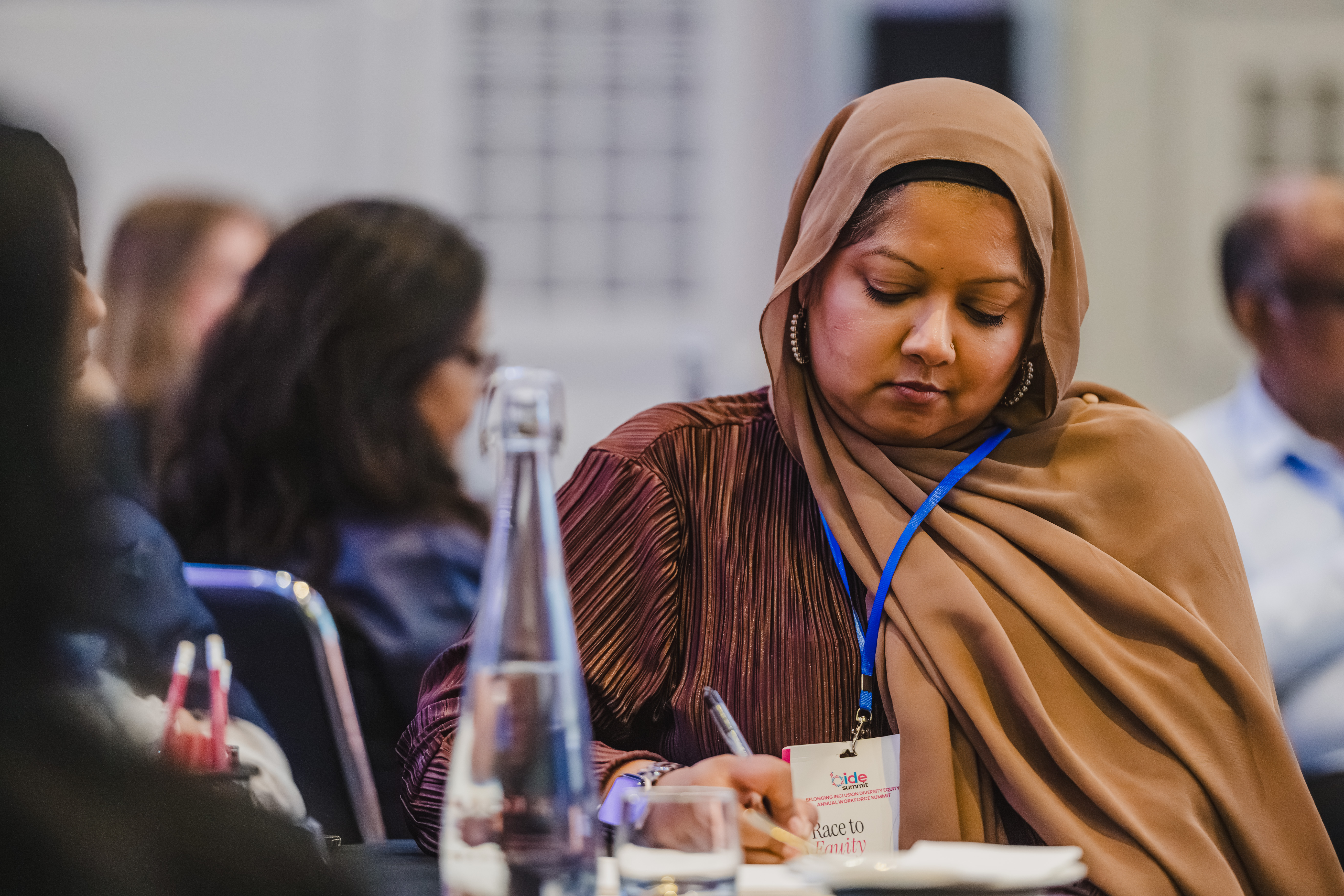 B.I.D.E summit delegate taking notes during a session