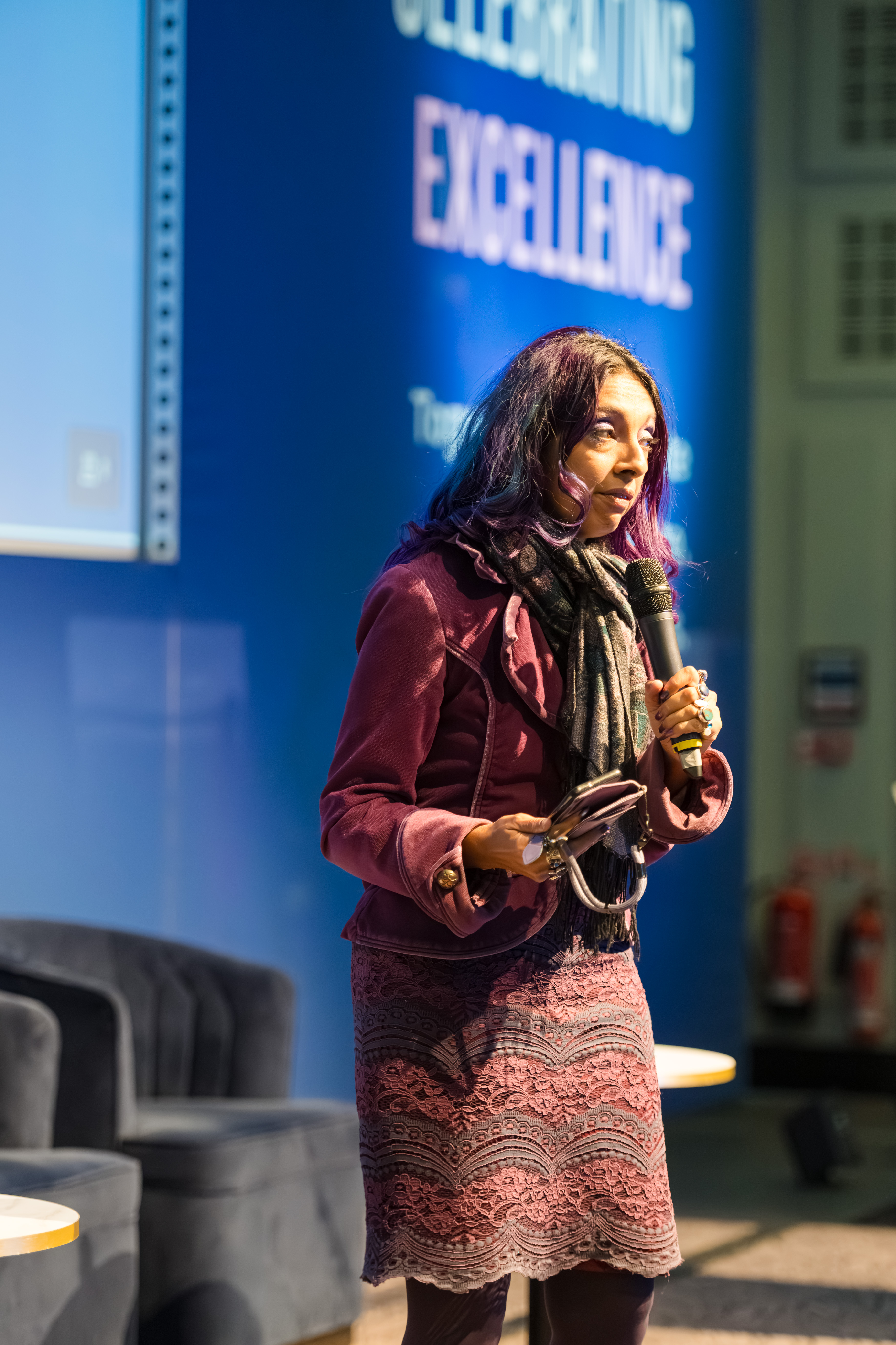 B.I.D.E summit speaker addressing delegates with a handheld microphone